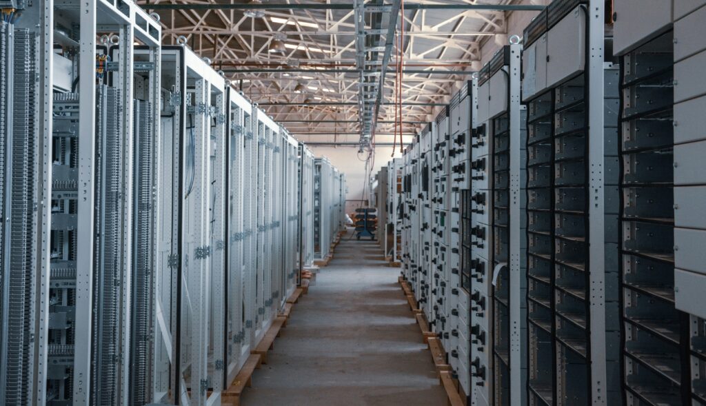 Neat rows of illuminated server racks in a data centre