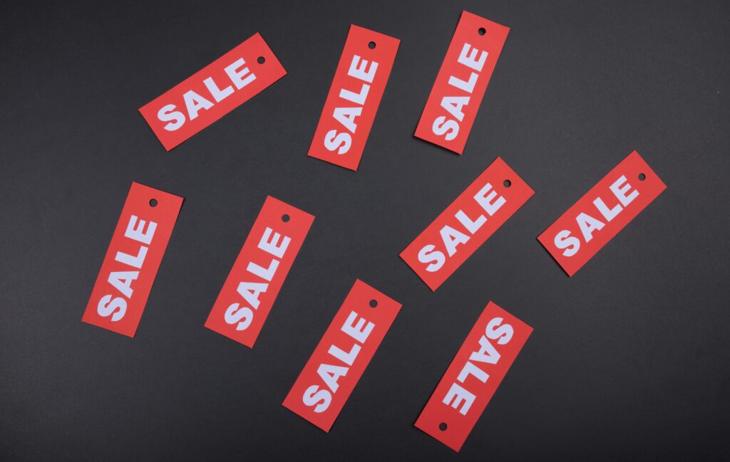 The words "sale" in white on a red rectangles that are on a black background.